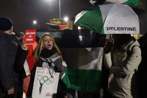 Anti-Israel Protest display banners and Palestine flags as the Olympic flame arrives in Milan, Italy - February 5, 2026.