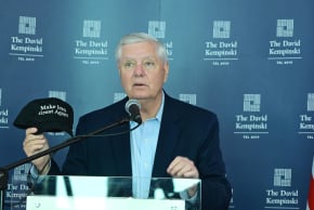 Senator Lindsey Graham holding a "Make Iran Great Again" hat during a speech at the David Kempinski hotel in Tel Aviv, February 16, 2026.
