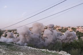 Flames and smoke errupt from the site of an Israeli airstrike that targeted a house in the southern Lebanese village of Tair Filsay on November 19, 2025.
