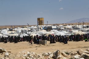 People walk at the Kurdish-run al-Hol camp, which holds relatives of suspected Islamic State (IS) group fighters in the northeastern Hasakeh governorate, on April 18, 2025.