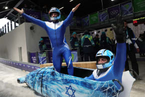 AJ EDELMAN reacts after his second heat run in the 2-man bobsleigh event at the Milano Cortina 2026 Winter Olympics