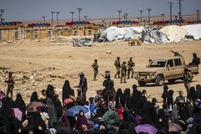 Members of the Syrian Kurdish Asayish security forces gather at the Kurdish-run al-Hol camp, which holds relatives of suspected Islamic State (IS) group fighters in the northeastern Hasakeh governorate, on April 18, 2025.