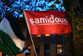 A photo shows a flag of the pro-Palestine organization 'Samidoun' during a "in solidarity with Gaza" demonstration in Duisburg, western Germany, on October 9, 2023.