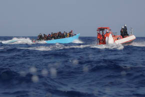  FILE PHOTO: Migrants aboard an overcrowded boat are approached by the crew of the migrant search and rescue ship Sea-Watch 5, operated by the German NGO Sea-Watch, during a rescue operation in the Search and Rescue (SAR) zone in the central Mediterranean, off Libya, August 11, 2025.