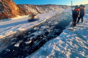 Rescuers work at the scene after a tour bus carrying Chinese tourists plunged into the ice‑covered waters of Lake Baikal in the Irkutsk region, Russia, February 20, 2026.