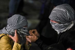 Pro-Palestinian demonstrators wear keffiyeh at a protest to condemn the interception of the vessels of the Global Sumud Flotilla, in Rome, Italy, October 1, 2025.