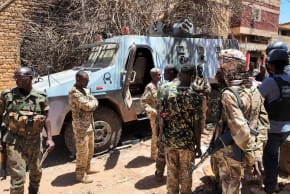 MEMBERS OF the Sudanese army gather next to a destroyed military vehicles after a battle with Rapid Support Forces (RSF) in the capital Khartoum, Sudan March 25, 2025.