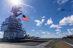 In this handout provided by the U.S. Navy, USS Gerald R. Ford (CVN 78), F/A-18E/F Super Hornets assigned to Strike Fighter Squadrons 31, 37, 87, and 213 from embarked Carrier Air Wing Eight, and a U.S. Air Force B-52 Stratofortress operate as a joint, multi-domain force, November 13, 2025. 