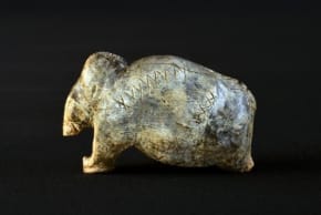 The mammoth figurine from Vogelherd Cave, approximately 40,000 years old, bears multiple sequences of crosses and dots on its surface.