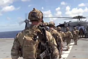 US forces prepare to board the vessel Veronica III, which tried to defy US President Donald Trump's quarantine, according to the US Department of Defense, in this screengrab obtained from a handout video released on February 15, 2026.