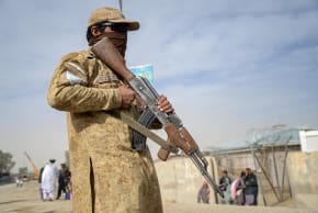 This photograph taken on December 29, 2025 shows a Taliban security personnel standing guard near the zero-point border crossing between Afghanistan and Pakistan at the Spin Boldak district of Kandahar province.