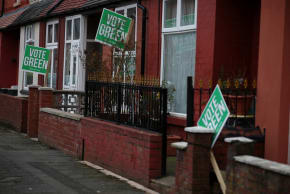 Signs in support of the Green Party stand outside houses in the constituency of Gorton and Denton ahead of a parliamentary by-election, in Manchester, Britain, February 18, 2026.