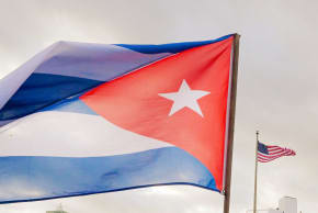 A Cuban soldier waves a national flag as he takes part in the "Anti-Imperialist" protest in front of the US Embassy against the US incursion in Venezuela, where 32 Cuban soldiers lost their lives, in Havana on January 16, 2026.