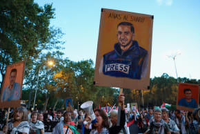 A woman displays a memorial sign of slain Palestinian Al Jazeera journalist Anas al-Sharif as people demonstrate during a general strike called by Spanish unions in solidarity with Palestinians in Gaza, in Madrid, Spain, October 15, 2025. 