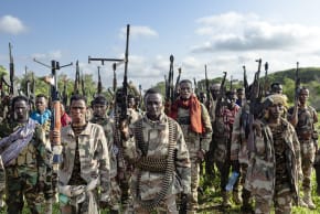 Soldiers of the Somalia National Army (SNA) raise their weapons when they gathered near their camp for a talk from visiting senior officers at Awdheegle, one of several towns recently liberated from the Al-Qaeda-linked terrorists in Somalia's lower-Shabelle region on November, 2025.