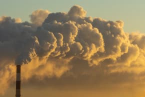 Factory chimney releases smoke.