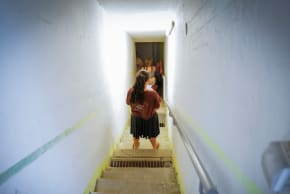 People take cover as siren warns of incoming missiles fired from Iran, at a public bomb shelter in Katzrin, northern Israel, June 19, 2025.