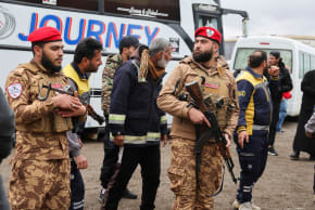 Members of the military police stand near a bus carrying released detainees during a prisoner exchange between the Syrian government and Druze factions, in Sweida, Syria, February 26, 2026.