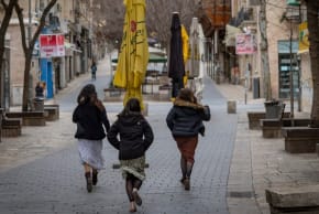 Pedestrians run for cover in central Jerusalem following incoming missile sirens amid the war between Israel and Iran, Feb. 28, 2026.