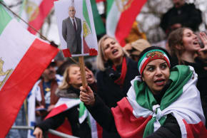 A WOMAN holds a placard with a picture of Reza Pahlavi as people gather outside the Iranian Embassy in London after Iran’s Supreme Leader Ayatollah Ali Khamenei was killed. 