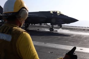 A screengrab from a video released by CENTCOM shows a flight deck crew member signaling an F‑35 jet on an aircraft carrier, in this image obtained from social media released on February 28, 2026
