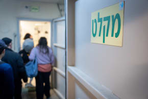 Israelis take cover in Tel Aviv as a siren sounds warning of incoming ballistic missiles fired from Iran toward Israel, March 1, 2026; illustrative.