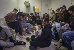ISRAELIS TAKE cover in a public shelter in Tel Aviv as a siren sounds warning of incoming ballistic missiles fired from Iran toward Israel, March 1, 2026.