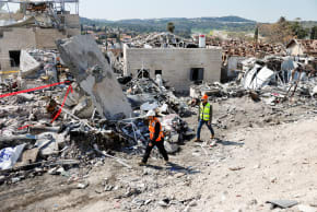 Debris lies at the site of a fatal Iranian missile strike in Israel on Monday. The war with Iran and the assassination of its supreme leader have temporarily pushed the anti-democratic and racist defects and ailments of Israel’s society to second place, the writer says.