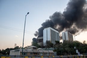 Smoke rises from the rubble of an Iranian state media building in Tehran after an Israeli airstrike on June 16, 2025. The strike, which Israel confirmed targeted "terror-linked propaganda infrastructure," marks a further escalation in regional tensions.
