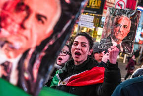 A woman holds a portrait of Reza Pahlavi, son of the last shah of Iran, during a “Freedom for Iran” protest in support of the Iranian people in New York on March 2, 2026.