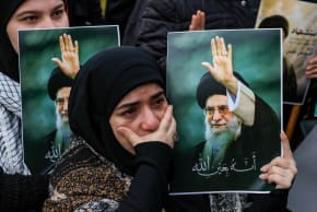 A woman reacts as she holds a placard with an image of Iranian slain Supreme Leader Ayatollah Ali Khamenei, in Beirut, Lebanon, March 1, 2026