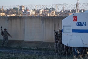 Turkish soldier guard the border while Pro-Kurdish protesters gather on top of a hill as they try to march to the border zone with the Kurdish-controlled northeastern Syrian city of Qamishli. January 20, 2026.