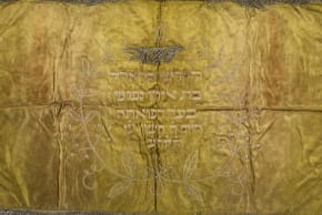A synagogue napkin made from satin, cotton and metal tassels is among the items being returned from Poland to Greece. 