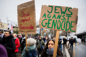 "Jews against genocide" is written on posters at a demonstration of several hundred people in Berlin, Dec. 23, 2023.