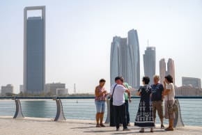 TOURISTS STAND near Etihad Towers in Abu Dhabi last week shortly after an Iranian missile attack.