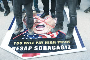 DEMONSTRATORS PROTESTING against the attacks on Iran step on a poster of US President Donald Trump, in Turkey, last week. While it’s true that America cannot fight every war, it is certainly obligated to fight against those who have threatened to finish it off, the writer says.