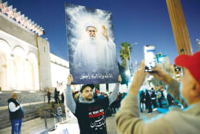 A DEMONSTRATOR holds an image of deceased Iranian Supreme Leader Ayatollah Ali Khamenei during a protest outside City Hall in Los Angeles, last week. The supreme leader thought he was invincible, but he was a lazy thinker, the writer notes.