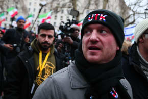 Tommy Robinson wears a UTK logo ("Unite The Kingdom") on his clothes as he is seen at a rally in solidarity with protesters in Iran on January 11, 2026 in London, England. 