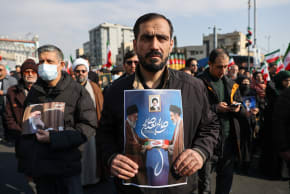 A man holds a placard with an image of Iran's new supreme leader Mojtaba Khamenei with late Iranian Supreme Leader Ayatollah Ali Khamenei, during a gathering to support Mojtaba Khamenei, amid the U.S.-Israeli conflict with Iran, in Tehran, Iran, March 9, 2026.