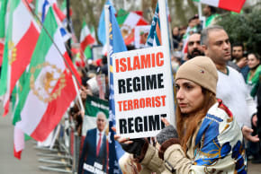 A demonstrator holds a placard during a protest against the Iranian government held by supporters of the Iranian royal family in exile, who marched through central London past the Iranian embassy to the Israeli embassy, in London, Britain, March 8, 2026