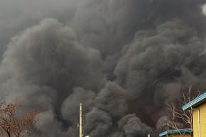 Smoke and flames rise at the site of airstrikes on an oil depot in Tehran on March 8, 2026. 