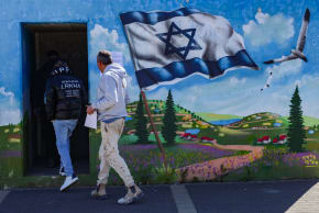 Israelis take cover in a public shelter in the northern Israeli city of Safed as a siren sounds warning of incoming missiles fired into Israel, March 10, 2026