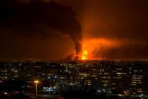 Smoke and flames rise at the site of airstrikes on an oil depot in Tehran on March 7, 2026. 