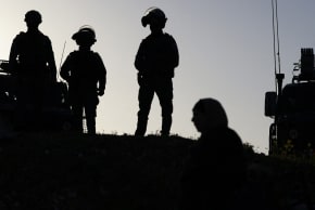 Israeli soldiers keep watch as Palestinian Muslims gather at the Qalandia checkpoint in the West Bank city of Ramallah on February 20, 2026, to enter Jerusalem on their way to Al-Aqsa Mosque for the first Friday noon prayers of the Islamic holy month of Ramadan.