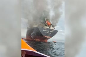 The Thailand-flagged cargo ship Mayuree Naree engulfed in black smoke in the Strait of Hormuz, March 11, 2026. (photo credit: ROYAL THAI NAVY/Handout via REUTERS)