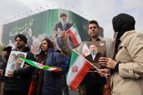People hold pictures of Iran's new supreme leader, Mojtaba Khamenei, during a funeral ceremony for the Iranian military commanders who were killed in strikes, amid the U.S.-Israeli conflict with Iran, in Tehran, Iran, March 11, 2026. 