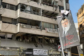 A banner with an image of slain Ayatollah Ali Khamenei next to damaged buildings in the aftermath of Israeli strikes, in Beirut's southern suburbs, Lebanon, March 12, 2026