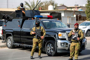Iraqi security forces stand guard during a funerary procession for a slain member of Iraq's Hashed al-Shaabi, or the Popular Mobilisation Forces (PMF) in Baghdad on March 8, 2026. 
