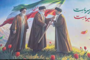 Here, a large poster shows (from left) the first leader of the Islamic Revolution, Ruhollah Khomeini; the second leader, Ali Khamenei; and on the right, the new leader of the revolution, Mojtaba Khamenei.