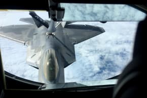 One of two US Air Force F-22 stealth fighter jets receives fuel mid-air from a KC-135 refueling plane over Norway en route to a joint training exercise with Norway's growing fleet of F-35 jets August 15, 2018. 
